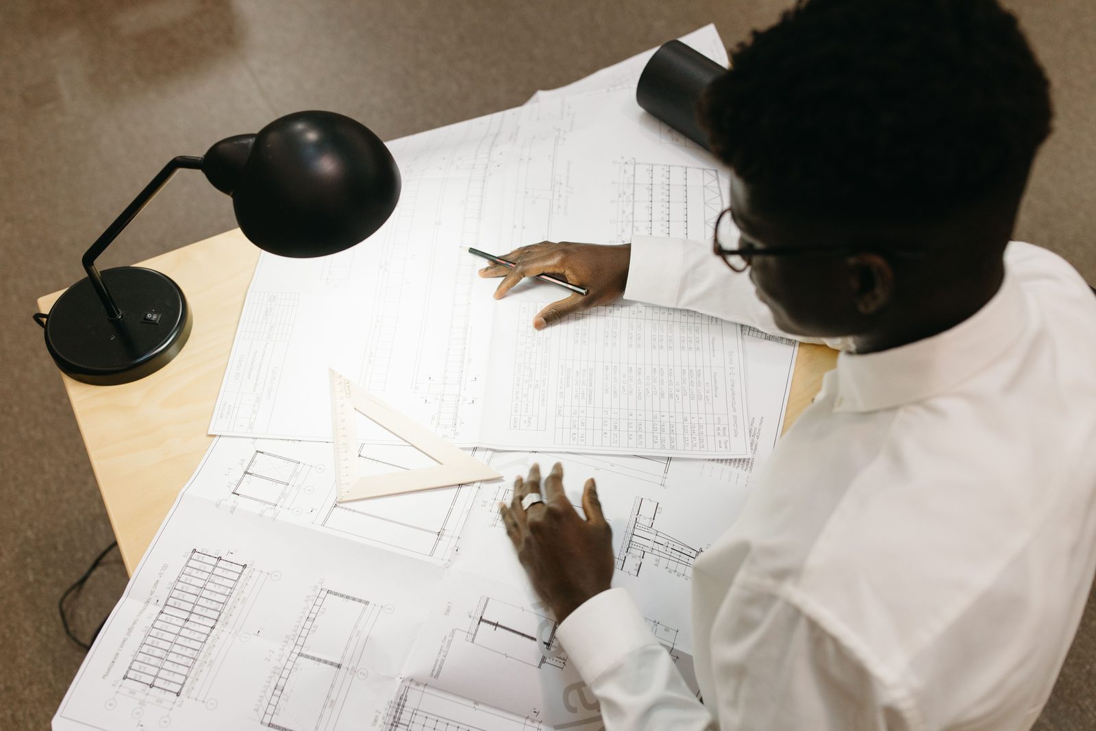 Engineer reviewing technical drawings